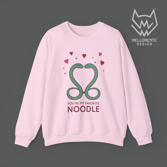 Light pink sweater featuring a cute valentine themed snake design captioned: "You're my favorite noodle."