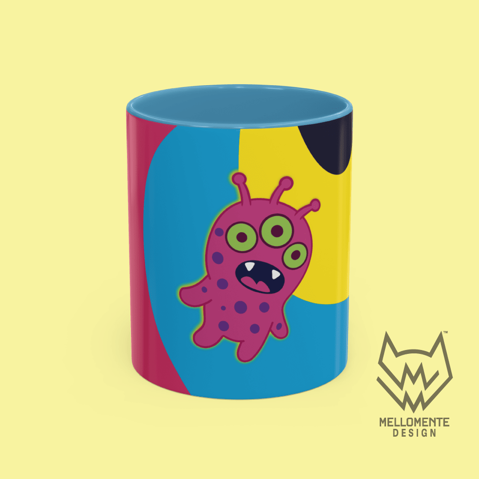 Ceramic mug with blue interior featuring colorful artwork with a pink alien creature on a solid background.
