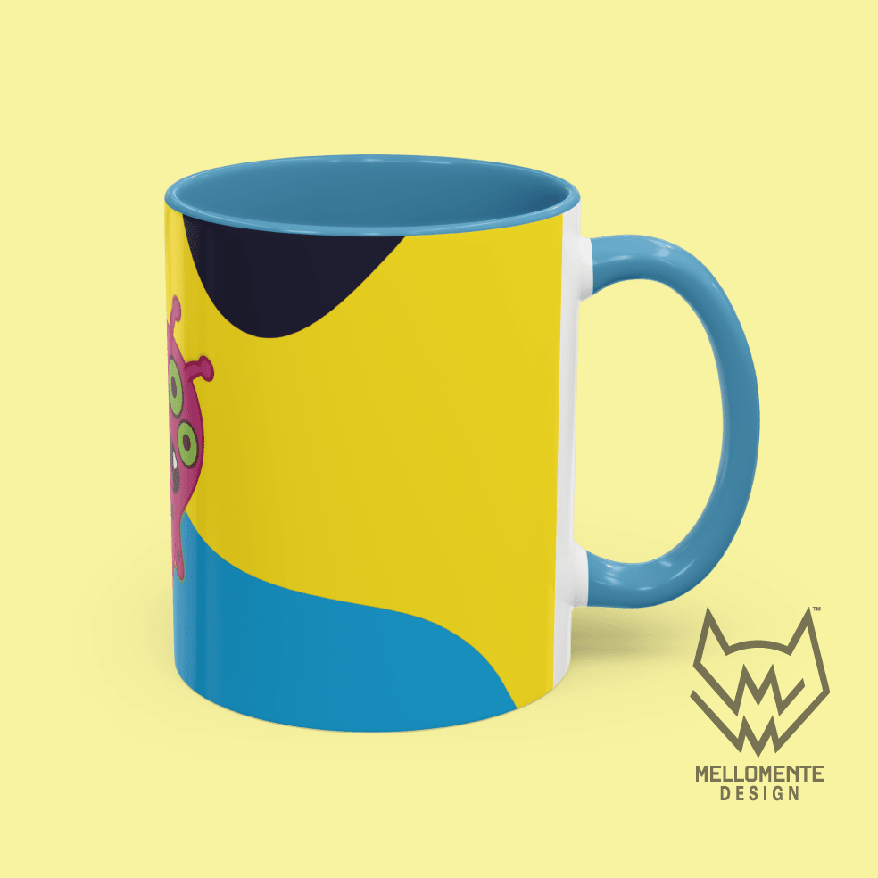 Ceramic mug with blue interior featuring colorful artwork with a pink alien creature on a solid background.