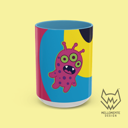 Ceramic mug with blue interior featuring colorful artwork with a pink alien creature on a solid background.