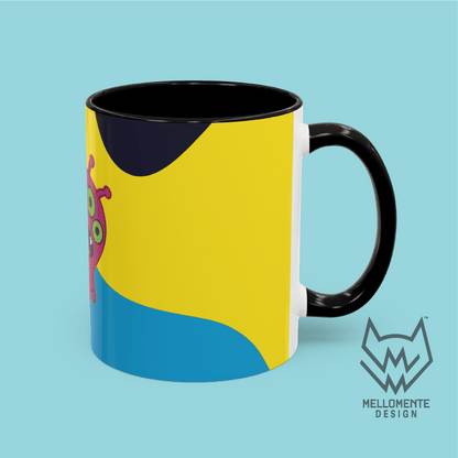 Ceramic mug with black interior featuring colorful artwork with a pink alien creature on a solid background.