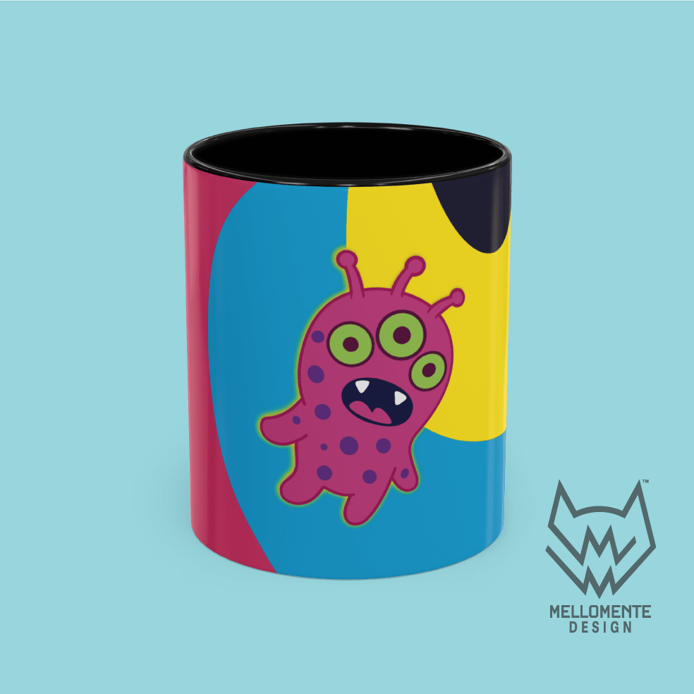 Ceramic mug with black interior featuring colorful artwork with a pink alien creature on a solid background.