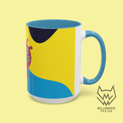 Ceramic mug with blue interior featuring colorful artwork with a pink alien creature on a solid background.