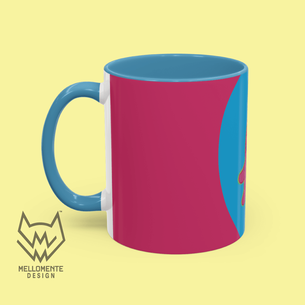 Ceramic mug with blue interior featuring colorful artwork with a pink alien creature on a solid background.