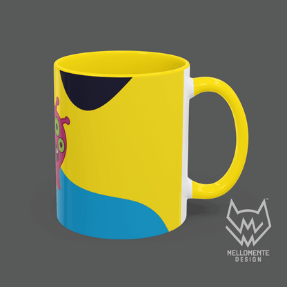 Ceramic mug with yellow interior featuring colorful artwork with a pink alien creature on a solid background.