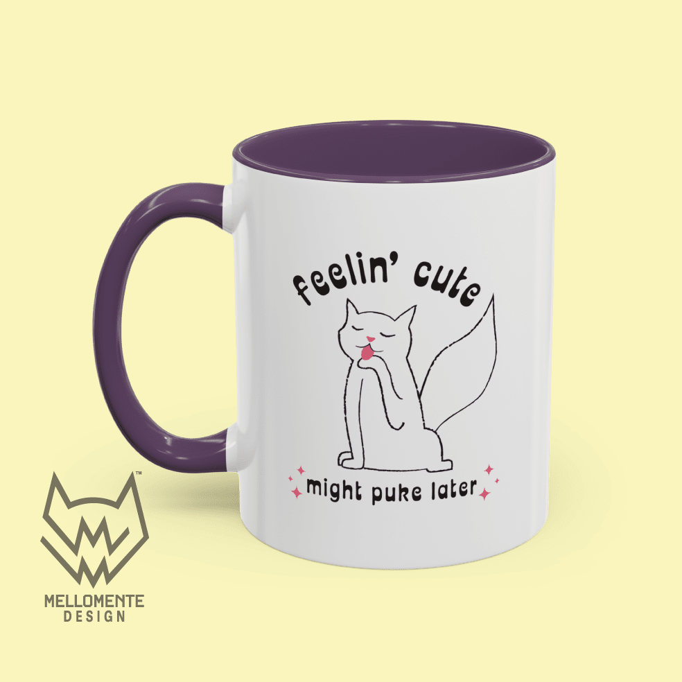 White mug with purple interior featuring a cat illustration and text 'Feelin' cute might puke later' on a solid background.