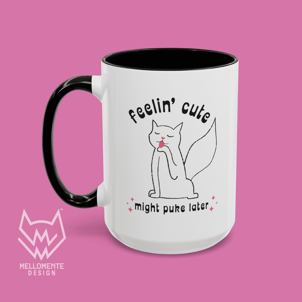 White mug with black interior featuring a cat illustration and text 'Feelin' cute might puke later' on a solid background.