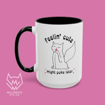 White mug with black interior featuring a cat illustration and text 'Feelin' cute might puke later' on a solid background.