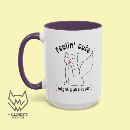 White mug with purple interior featuring a cat illustration and text 'Feelin' cute might puke later' on a solid background.