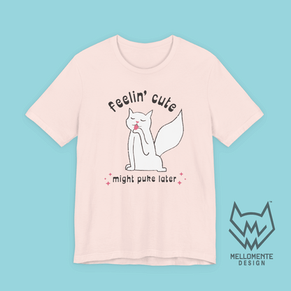 Pink t-shirt with a cat graphic and text on a solid background.