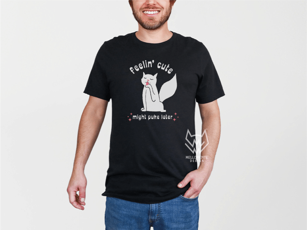 Person wearing a black t-shirt with a white cat graphic design and text on a plain background