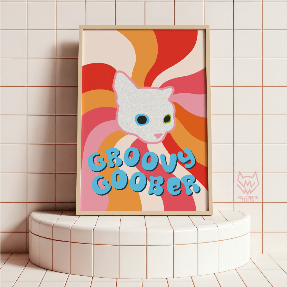 Framed artwork with a cartoon cat face and 'Groovy Goober' text on a tiled wall. Framed art shown as display suggestion.