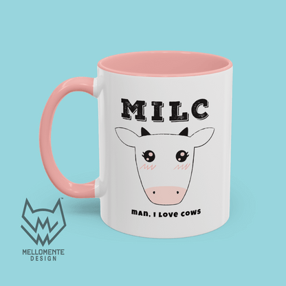 White mug with pink interior featuring cow illustration and text 'MILC - Man, I love cows' on a solid background.