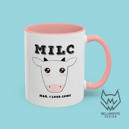 White mug with pink interior featuring cow illustration and text 'MILC - Man, I love cows' on a solid background.