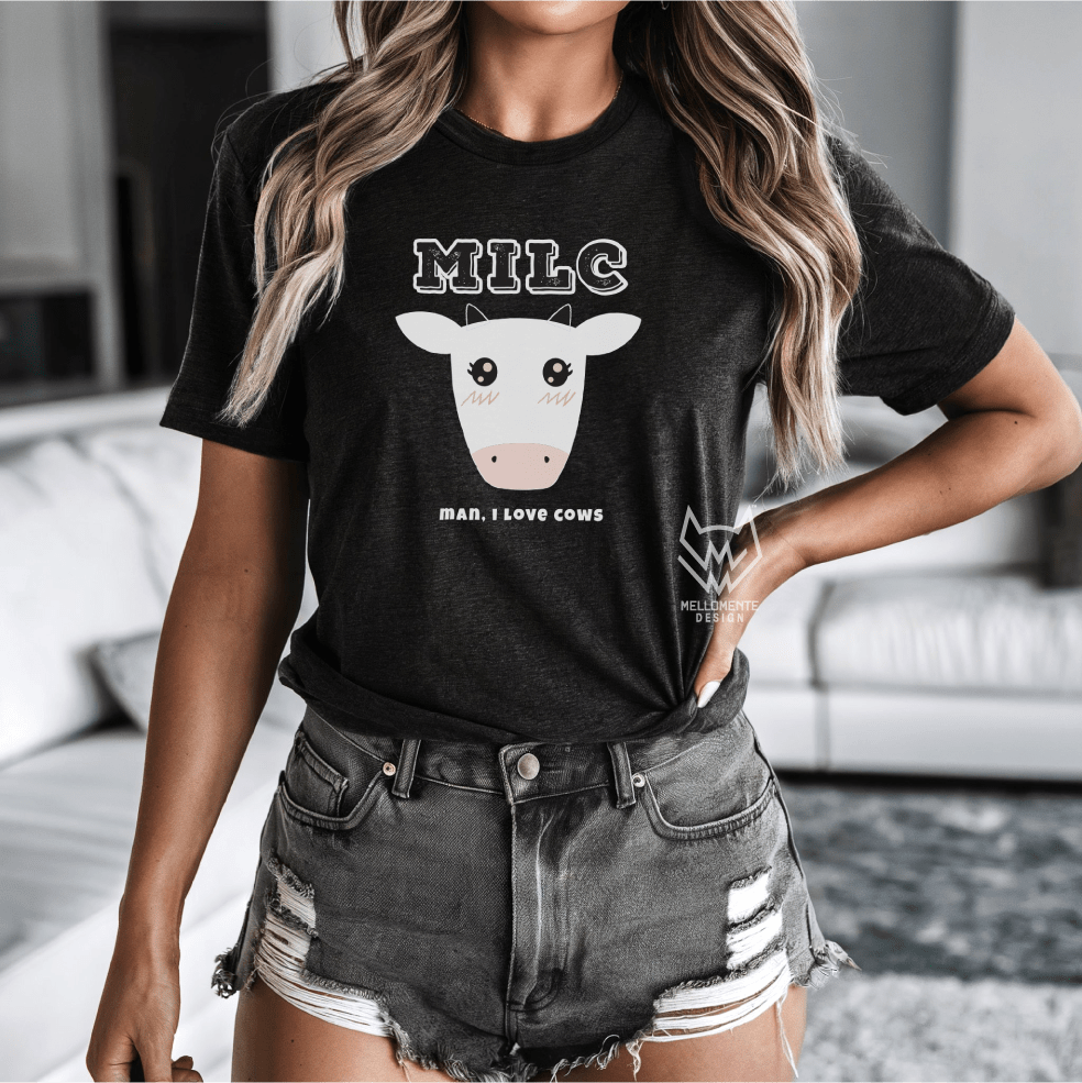 Person wearing a black t-shirt with a cow graphic and text in a casual setting.
